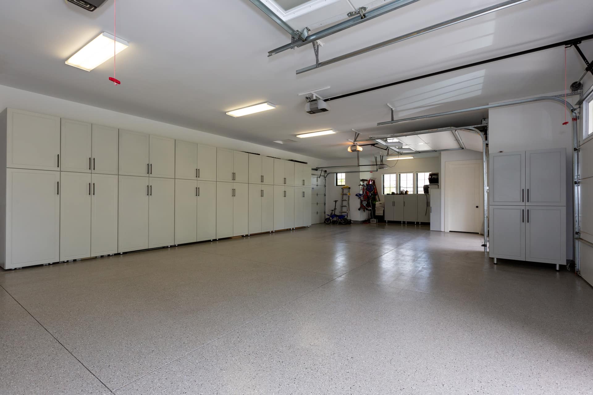 Custom garage cabinets and storage system configured for sports and utility equipment